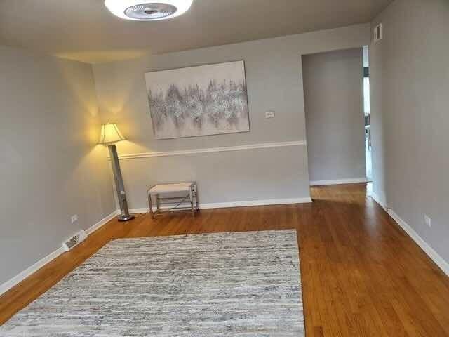605 Hoxie Ave, Calumet City, IL 60409 - unfurnished room featuring wood finished floors and baseboards