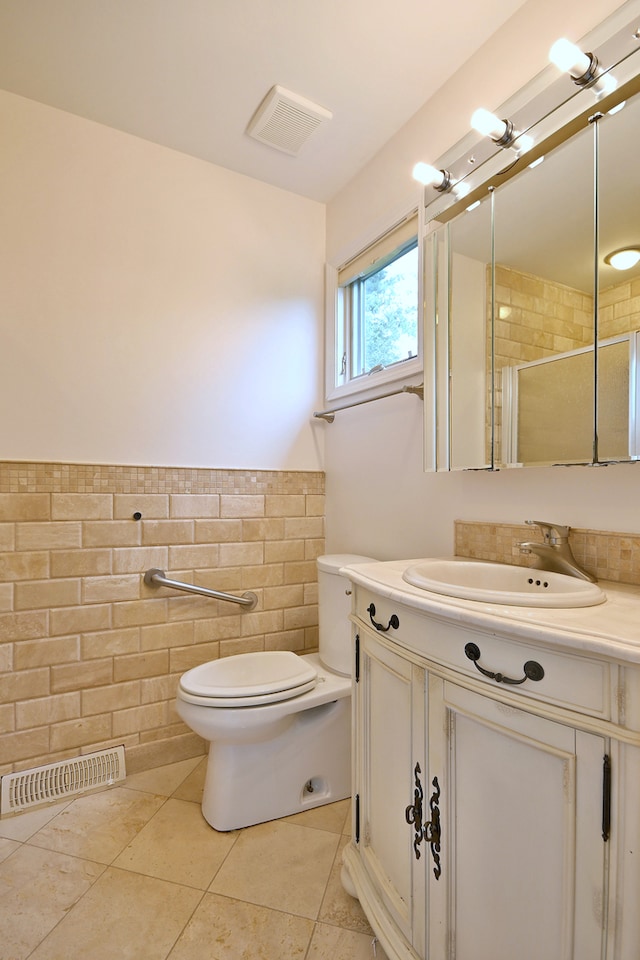 105 Haman Rd, Inverness, IL 60067 - bathroom with vanity, tile walls, a wainscoted wall, tiled shower, and tile patterned floors