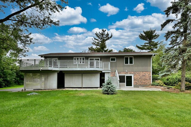 105 Haman Rd, Inverness, IL 60067 - back of property with a deck, a yard, and brick siding