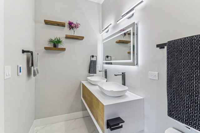 2307 N Avers Ave Unit 2, Chicago, IL 60647 - bathroom with double vanity and marble look tile flooring