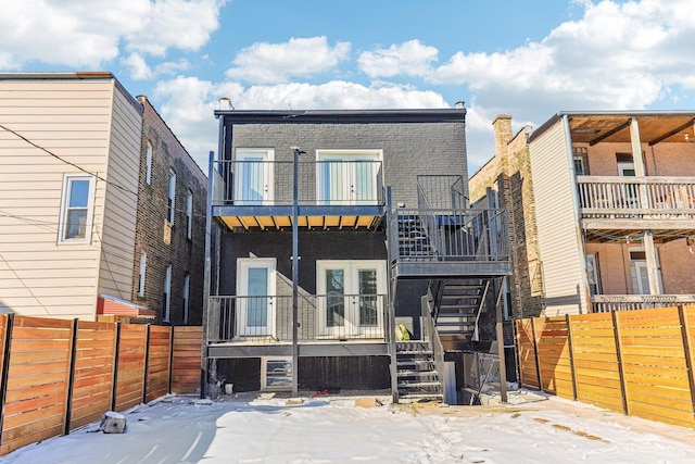 2307 N Avers Ave Unit 2, Chicago, IL 60647 - snow covered house featuring stairway, brick siding, and a balcony