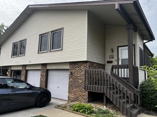 1318 Kingsbury Dr Unit 1, Hanover Park, IL 60133 - view of front facade featuring brick siding and a garage