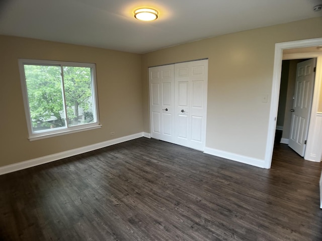 1318 Kingsbury Dr Unit 1, Hanover Park, IL 60133 - unfurnished bedroom featuring dark wood-style flooring and a closet