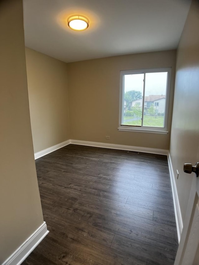 1318 Kingsbury Dr Unit 1, Hanover Park, IL 60133 - spare room with dark wood finished floors and baseboards