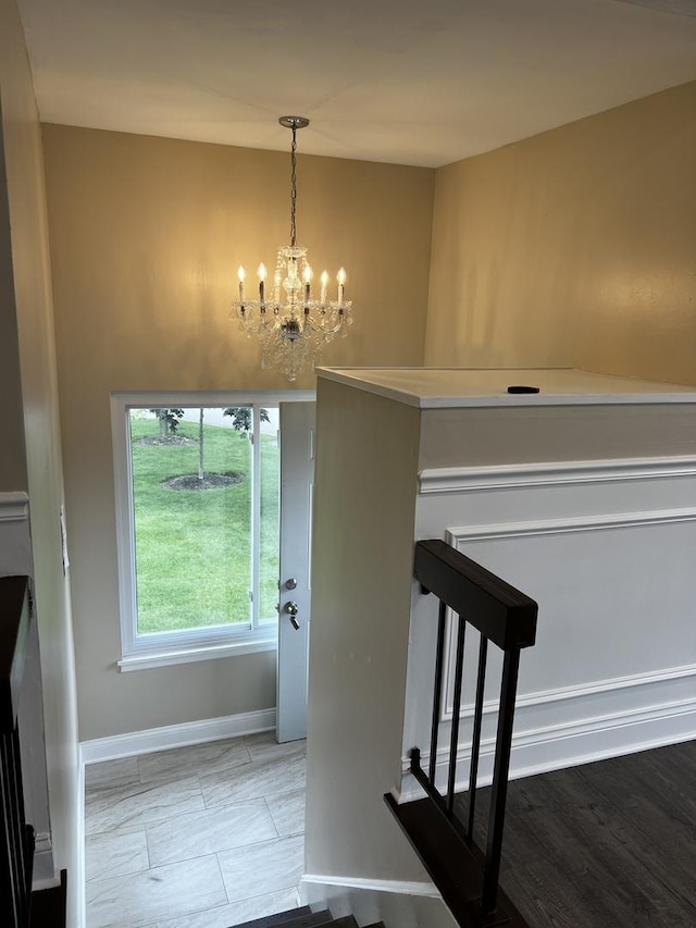 1318 Kingsbury Dr Unit 1, Hanover Park, IL 60133 - stairway featuring a chandelier and baseboards