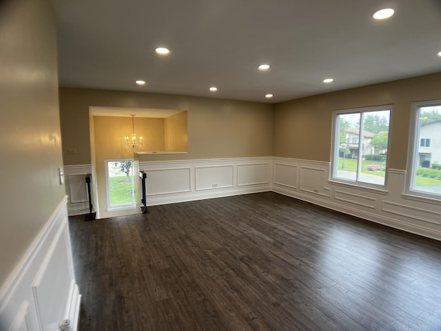 1318 Kingsbury Dr Unit 1, Hanover Park, IL 60133 - unfurnished living room featuring a chandelier, dark wood-type flooring, a wainscoted wall, recessed lighting, and plenty of natural light