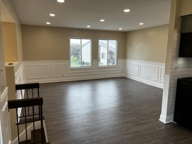 1318 Kingsbury Dr Unit 1, Hanover Park, IL 60133 - unfurnished living room featuring a wainscoted wall, a fireplace, a decorative wall, dark wood-type flooring, and recessed lighting
