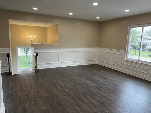 1318 Kingsbury Dr Unit 1, Hanover Park, IL 60133 - spare room with a chandelier, wainscoting, a decorative wall, dark wood-style flooring, and recessed lighting