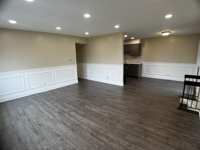 1318 Kingsbury Dr Unit 1, Hanover Park, IL 60133 - unfurnished living room featuring a decorative wall, a wainscoted wall, dark wood-type flooring, and recessed lighting