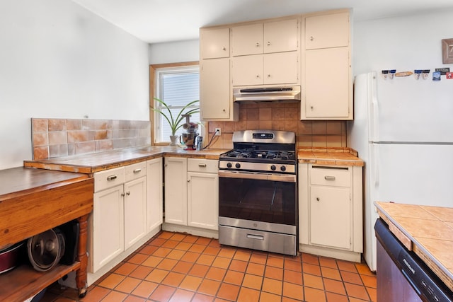 1330 W Norwood Ave, Chicago, IL 60660 - kitchen featuring appliances with stainless steel finishes, under cabinet range hood, tile countertops, tasteful backsplash, and light tile patterned floors