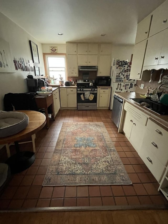 1330 W Norwood Ave, Chicago, IL 60660 - kitchen featuring appliances with stainless steel finishes, under cabinet range hood, tile patterned flooring, and cream cabinetry