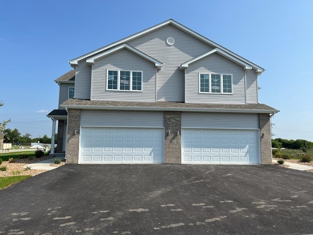 1583 Glenbrooke Ln, New Lenox, IL 60451 - view of front facade with an attached garage, asphalt driveway, and brick siding