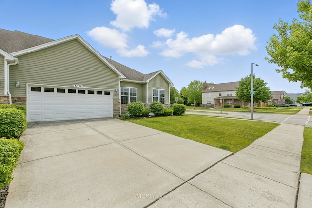 15701 Cove Cir, Plainfield, IL 60544 - view of front of property with stone siding, a front lawn, an attached garage, driveway, and a shingled roof