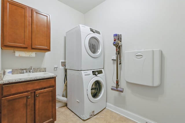 15701 Cove Cir, Plainfield, IL 60544 - laundry room featuring stacked washer and clothes dryer, cabinet space, and light tile patterned floors