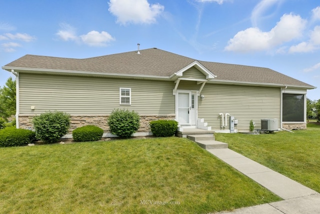 15701 Cove Cir, Plainfield, IL 60544 - view of front of home with a front lawn, stone siding, a sunroom, and roof with shingles