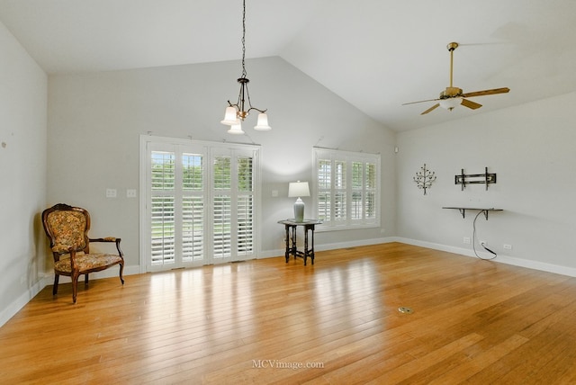 15701 Cove Cir, Plainfield, IL 60544 - living room featuring ceiling fan, high vaulted ceiling, light wood-style floors, and a chandelier