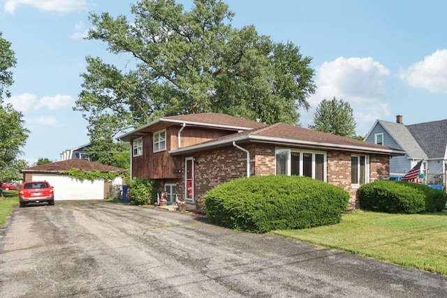 10956 S Nagle Ave, Worth, IL 60482 - split level home with brick siding, a detached garage, an outbuilding, and a front lawn