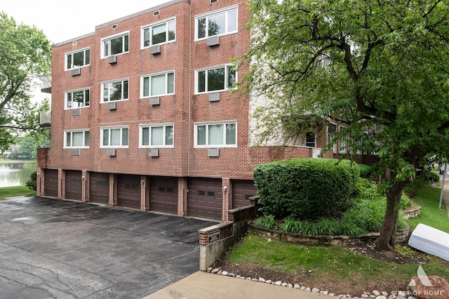 101 N Peartree Ln Unit 101, Arlington Heights, IL 60004 - view of building exterior featuring driveway