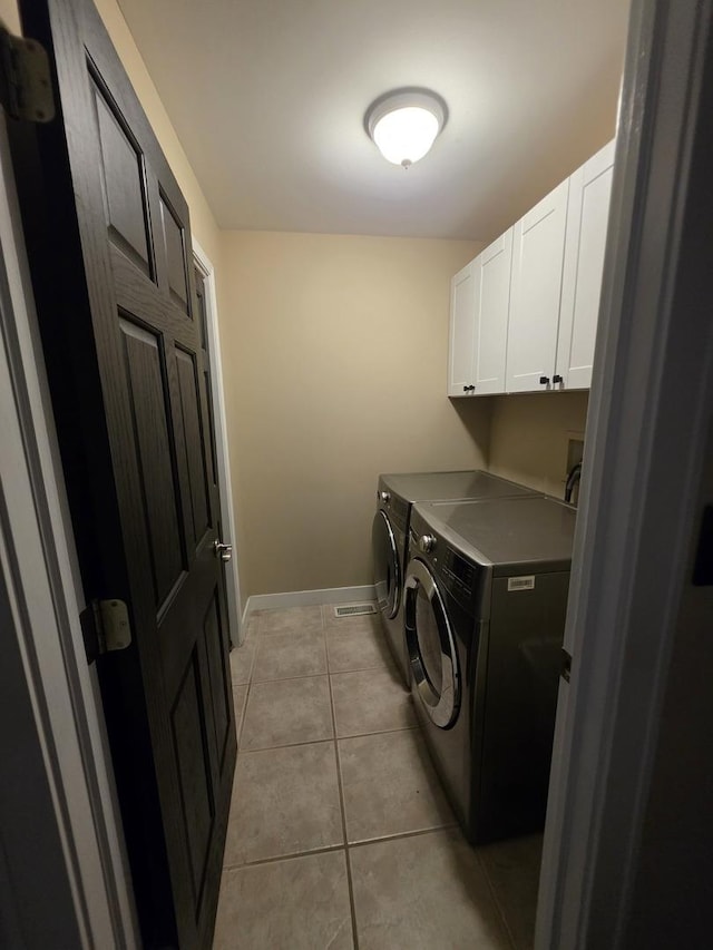 723 Casey Dr, Minooka, IL 60447 - laundry area with cabinet space, washer and dryer, and light tile patterned floors
