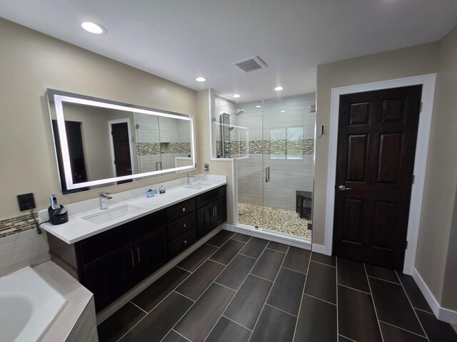 723 Casey Dr, Minooka, IL 60447 - bathroom featuring a shower stall, double vanity, a bath, and recessed lighting