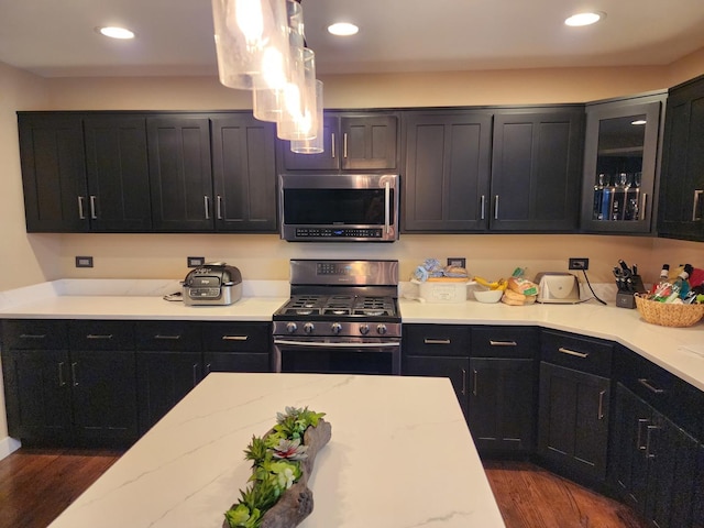 723 Casey Dr, Minooka, IL 60447 - kitchen with stainless steel microwave, range with gas stovetop, dark cabinetry, and recessed lighting