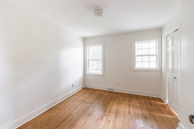 310 Virgil St, Maple Park, IL 60151 - unfurnished bedroom featuring light wood finished floors, multiple windows, and a closet