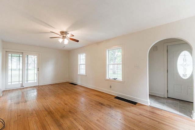 310 Virgil St, Maple Park, IL 60151 - entrance foyer with arched walkways, ceiling fan, light wood finished floors, and healthy amount of natural light