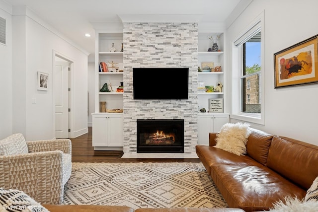 2242 W Lawrence Ave Unit 203, Chicago, IL 60625 - living room featuring a stone fireplace, wood finished floors, built in features, and ornamental molding