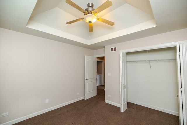 340 Hubbard Ave, Elgin, IL 60123 - unfurnished bedroom featuring a tray ceiling, carpet floors, a closet, ceiling fan, and washer / clothes dryer