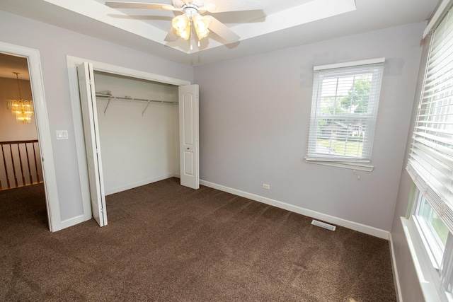 340 Hubbard Ave, Elgin, IL 60123 - unfurnished bedroom with dark colored carpet, multiple windows, a closet, and a ceiling fan