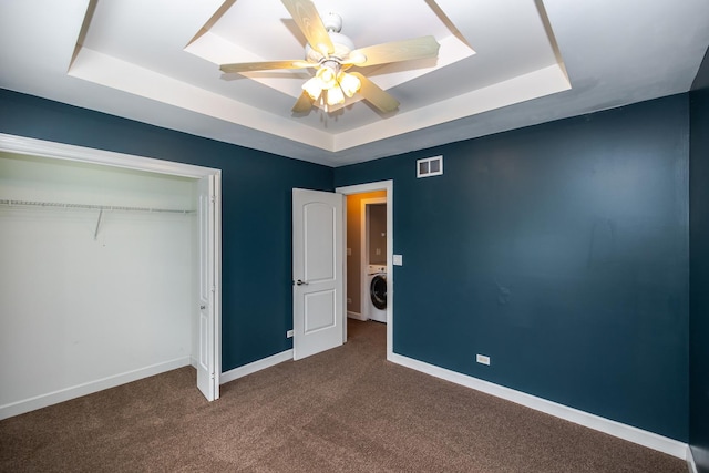 340 Hubbard Ave, Elgin, IL 60123 - unfurnished bedroom featuring a raised ceiling, washer / clothes dryer, dark colored carpet, and a closet