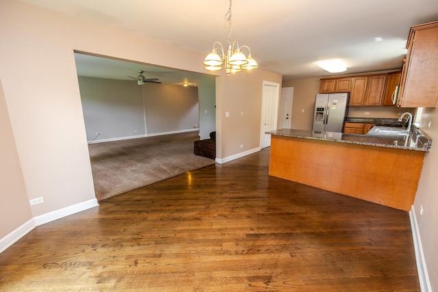 340 Hubbard Ave, Elgin, IL 60123 - kitchen with stainless steel refrigerator with ice dispenser, brown cabinetry, dark wood-type flooring, dark stone counters, and pendant lighting