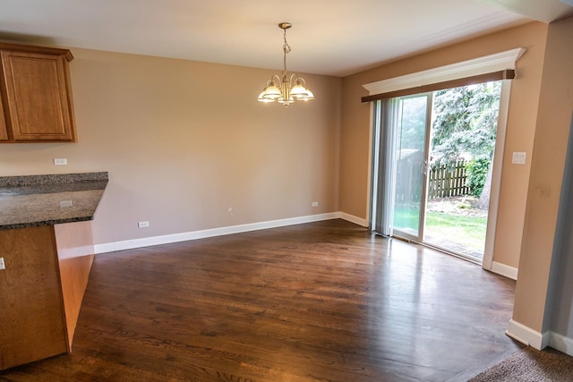 340 Hubbard Ave, Elgin, IL 60123 - unfurnished dining area with a chandelier and dark wood-style flooring