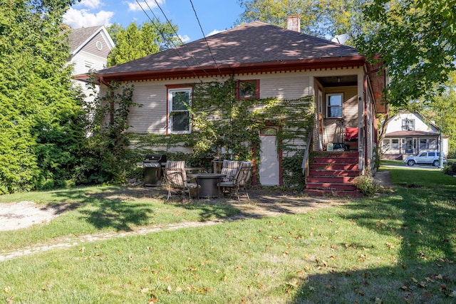 808 Glenwood Ave, Joliet, IL 60435 - back of property with a lawn, a chimney, and a shingled roof