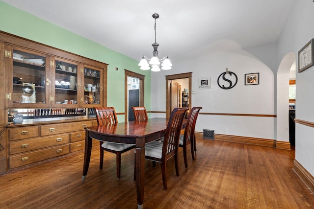 808 Glenwood Ave, Joliet, IL 60435 - dining area with a chandelier, dark wood-type flooring, and arched walkways