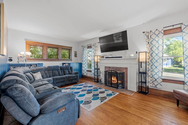 808 Glenwood Ave, Joliet, IL 60435 - living room with healthy amount of natural light, wood finished floors, and a brick fireplace