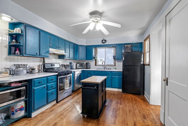 808 Glenwood Ave, Joliet, IL 60435 - kitchen featuring stainless steel appliances, blue cabinets, under cabinet range hood, and open shelves