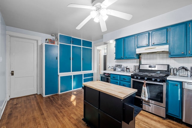 808 Glenwood Ave, Joliet, IL 60435 - kitchen with blue cabinetry, stainless steel appliances, under cabinet range hood, and wood counters
