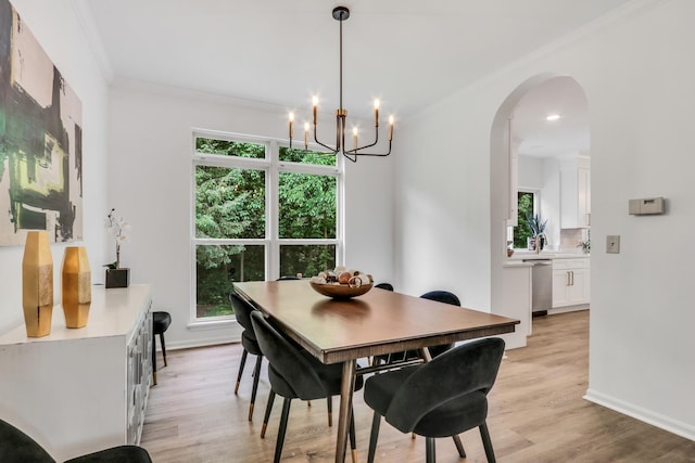 7612 Cascade Way, Gurnee, IL 60031 - dining room with healthy amount of natural light, arched walkways, light wood-type flooring, a chandelier, and ornamental molding