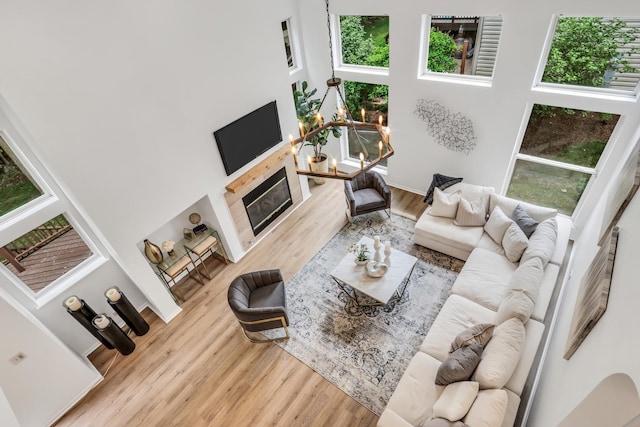 7612 Cascade Way, Gurnee, IL 60031 - living room with plenty of natural light, wood finished floors, a glass covered fireplace, and a high ceiling
