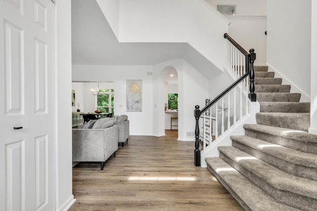 7612 Cascade Way, Gurnee, IL 60031 - entrance foyer with light wood finished floors, stairway, a high ceiling, and arched walkways