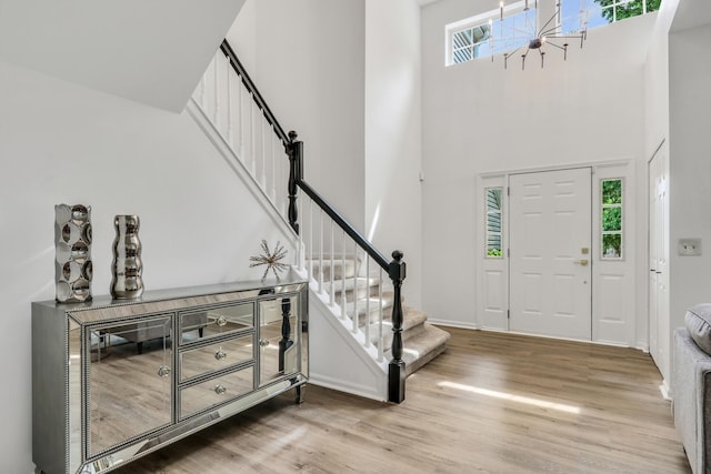 7612 Cascade Way, Gurnee, IL 60031 - entrance foyer featuring stairway, wood finished floors, a high ceiling, and a chandelier