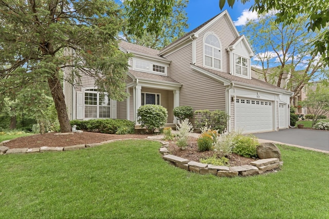 7612 Cascade Way, Gurnee, IL 60031 - traditional-style house with an attached garage, asphalt driveway, a front yard, and roof with shingles