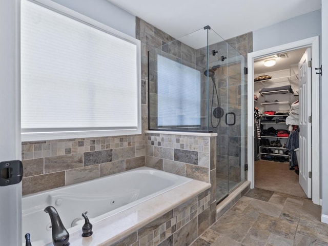 569 Ryan Way, Crystal Lake, IL 60012 - full bathroom with a tub with jets, a stall shower, a walk in closet, and stone finish flooring