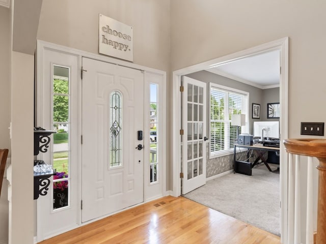569 Ryan Way, Crystal Lake, IL 60012 - carpeted foyer featuring wood finished floors, ornamental molding, and a towering ceiling
