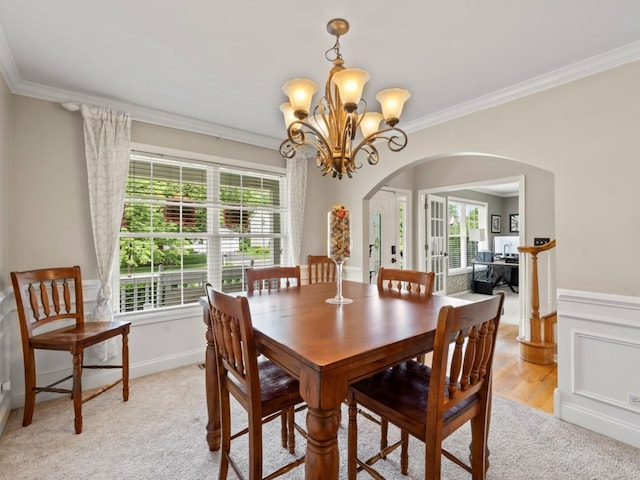 569 Ryan Way, Crystal Lake, IL 60012 - dining space featuring arched walkways, crown molding, healthy amount of natural light, a chandelier, and light colored carpet