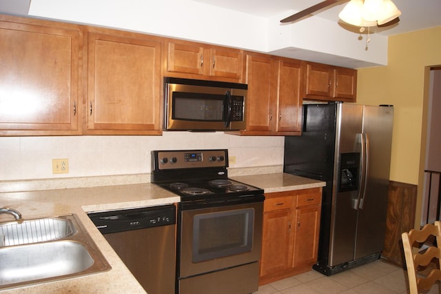 4184 Cove Ln Unit D, Glenview, IL 60025 - kitchen with stainless steel appliances, light countertops, brown cabinetry, backsplash, and ceiling fan