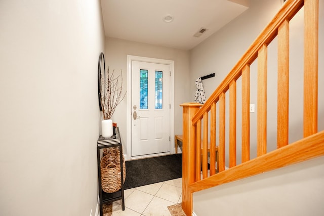 3457 N Whipple St, Chicago, IL 60618 - entryway with stairway, light tile patterned flooring, and light carpet