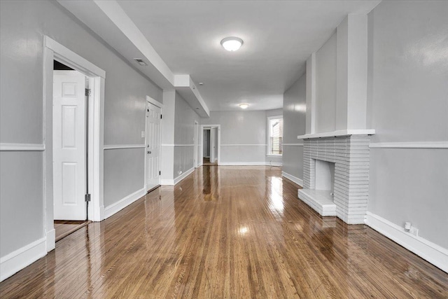 4336 W Adams St, Chicago, IL 60624 - unfurnished living room with wood finished floors and a brick fireplace