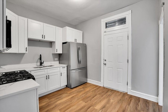 4336 W Adams St, Chicago, IL 60624 - kitchen featuring freestanding refrigerator, white cabinets, and light wood-type flooring
